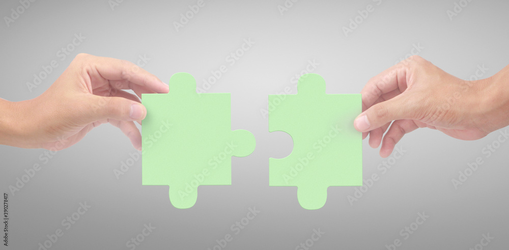 Hand of connecting jigsaw puzzle,Concept of teamwork Hand of connecting jigsaw puzzle,Concept of teamwork