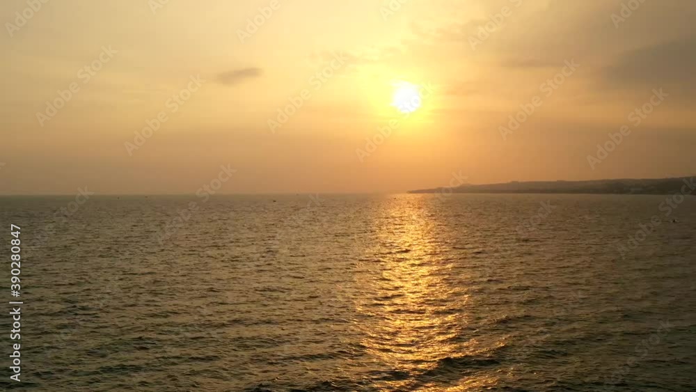 Time-lapse video of beautiful sunset on the sea. Sun is down to ocean, we see fishing boat and sun path and fast moving sunset clouds. Aerial view to sunset time-lapse Time-lapse video of beautiful sunset on the sea. Sun is down to ocean, we see fishing boat and sun path and fast moving sunset clouds. Aerial view to sunset time-lapse
