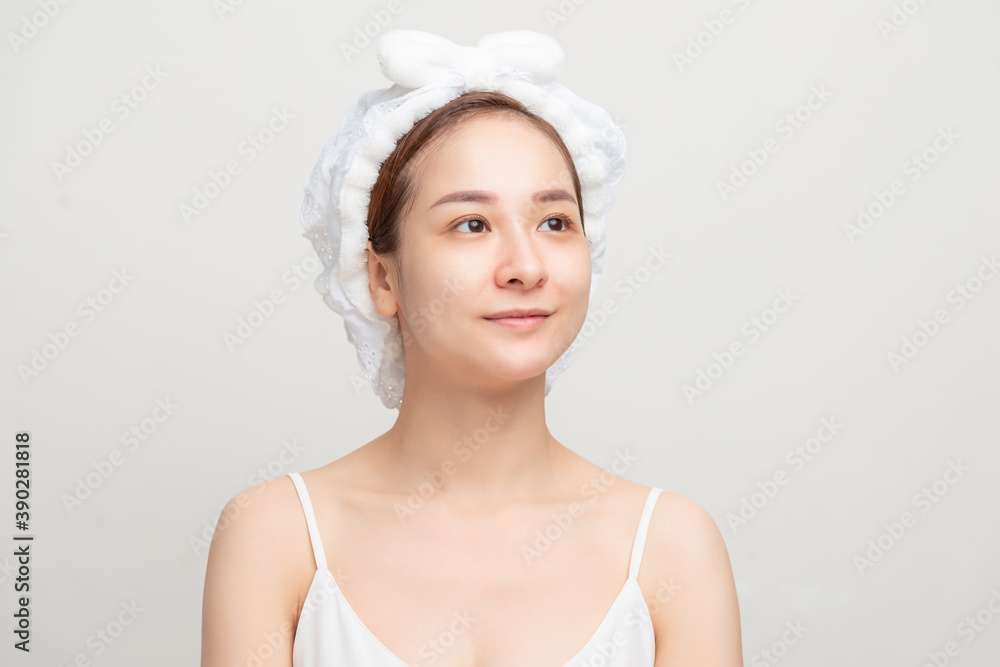 beautiful young woman with bath towel on head covering on white wall beautiful young woman with bath towel on head covering on white wall