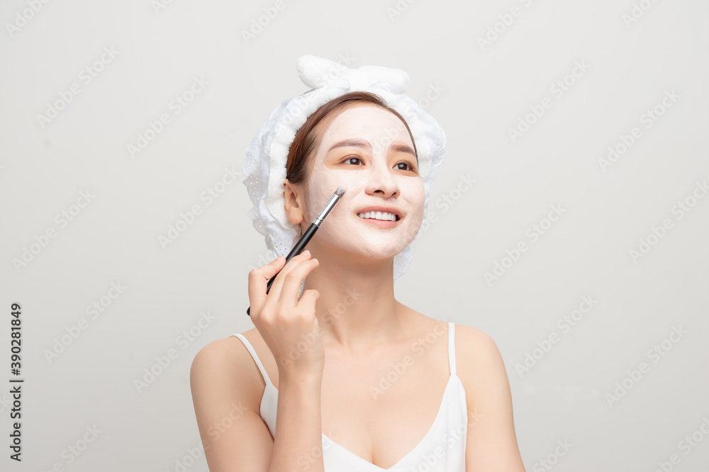 Woman with lifting cream applied on her face, isolated on white Woman with lifting cream applied on her face, isolated on white