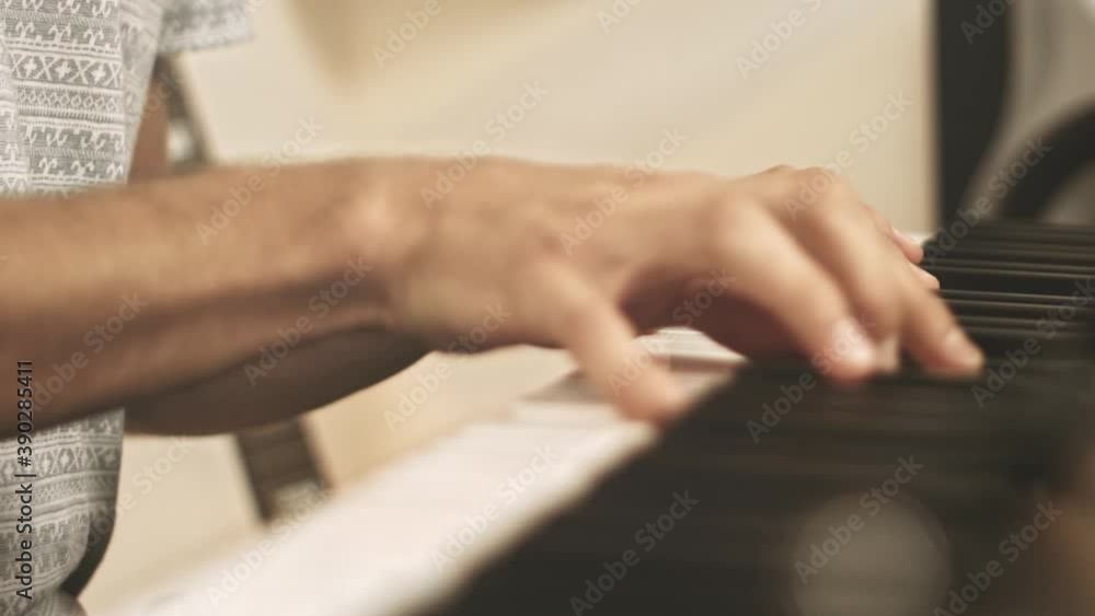 Close up of a professional piano player playing and improvising on a stage piano during a recording session with a bright background. Shallow depth; racking focus. Shot in 4K. Close up of a professional piano player playing and improvising on a stage piano during a recording session with a bright background. Shallow depth; racking focus. Shot in 4K.