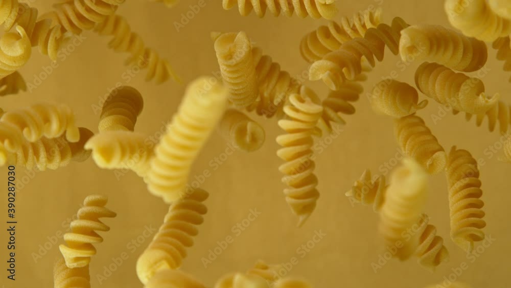Super slow motion of flying uncooked italian pasta on golden background. Filmed on high speed cinema camera, 1000 fps. Super slow motion of flying uncooked italian pasta on golden background. Filmed on high speed cinema camera, 1000 fps.