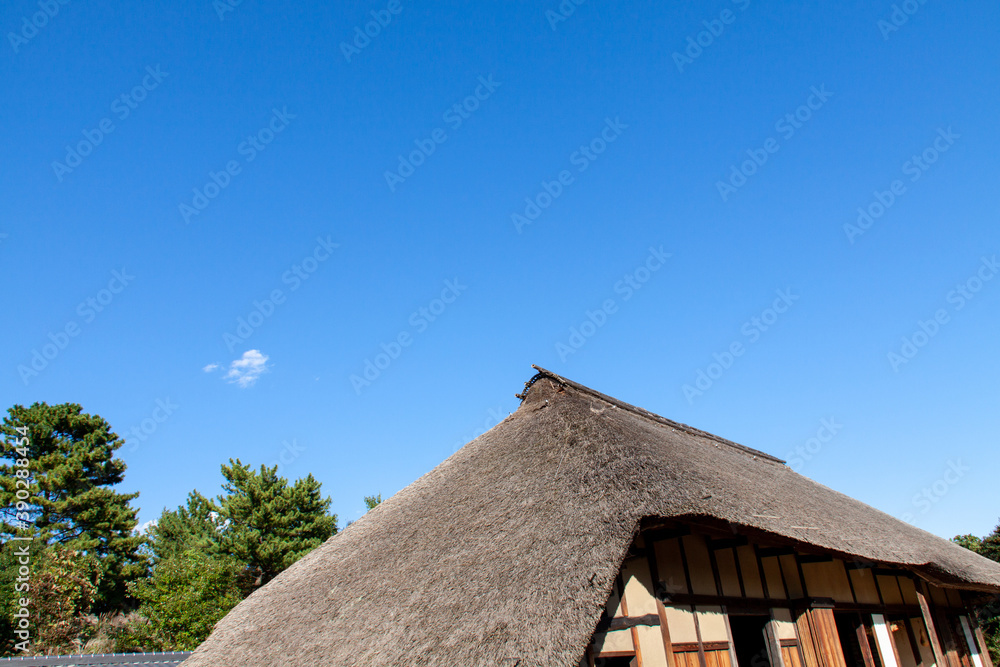 Japanese Thatched Roof House against the Blue Sky Japanese Thatched Roof House against the Blue Sky