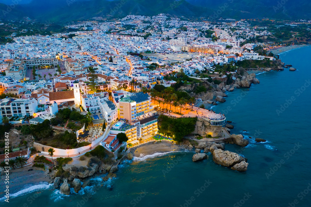 Aerial view of illuminated Nerja city at Mediterranean coast, Costa del Sol, Spain