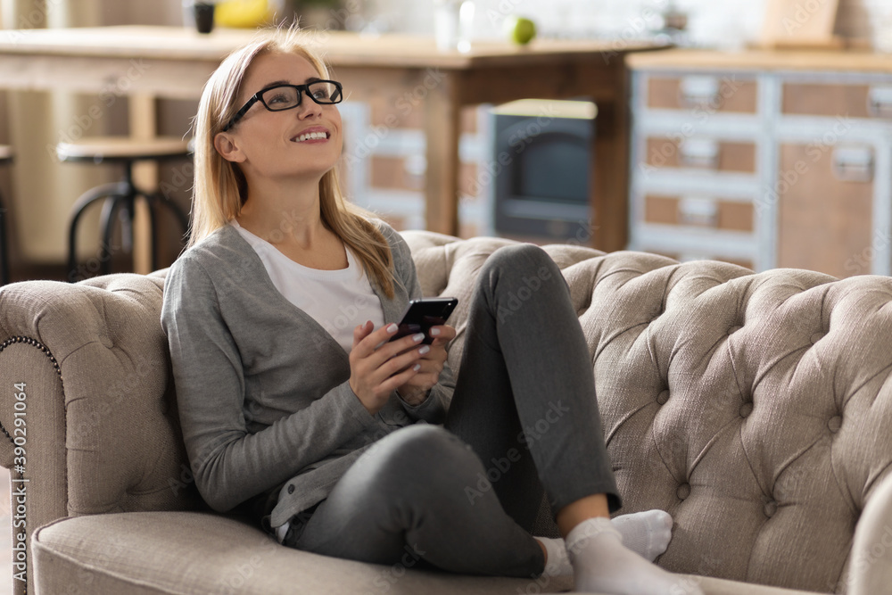 Beautiful woman chatting while sitting on the couch at home. Happy with online communication Beautiful woman chatting while sitting on the couch at home. Happy with online communication