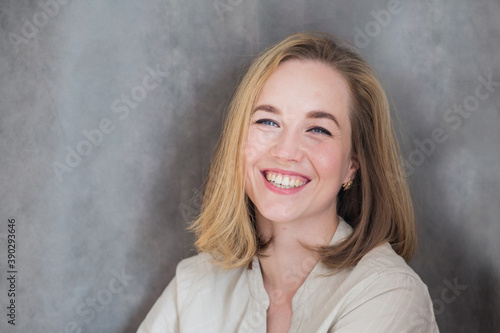 Happy beautiful blonde European woman close up portrait 