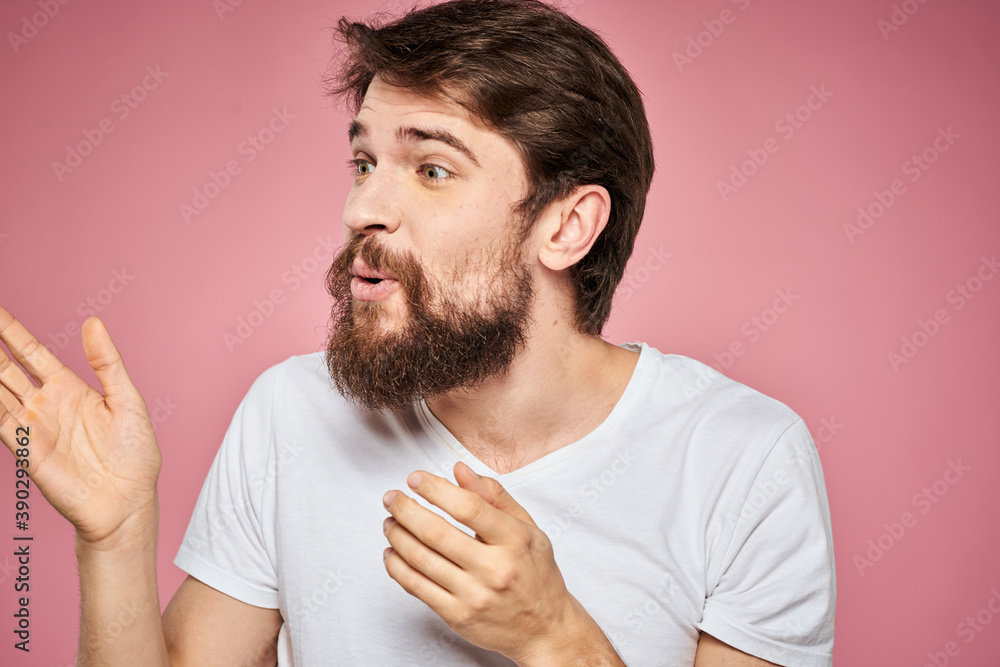 Man in white t-shirt emotions lifestyle facial expression cropped view pink background. Man in white t-shirt emotions lifestyle facial expression cropped view pink background.