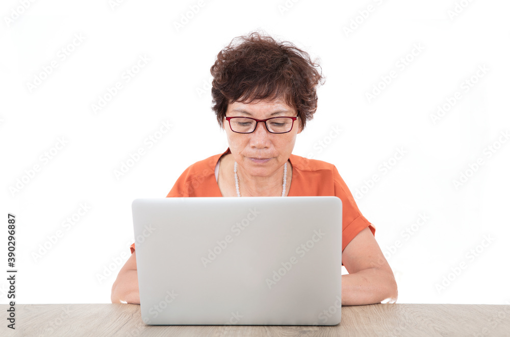 Old Chinese lady is sitting at the computer and typing seriously Old Chinese lady is sitting at the computer and typing seriously
