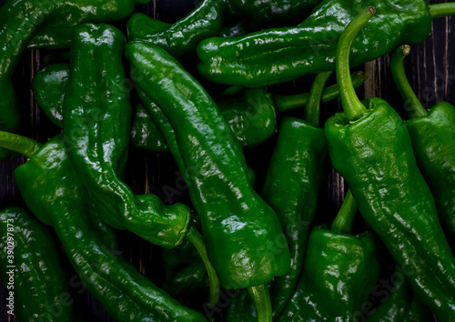 Raw green hot mexican peppers jalapeno pimientos padron spanish tapas, background