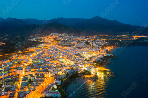 Aerial view of Nerja city with coastline in province of Malaga at night, Andalusia, southern Spain © JackF