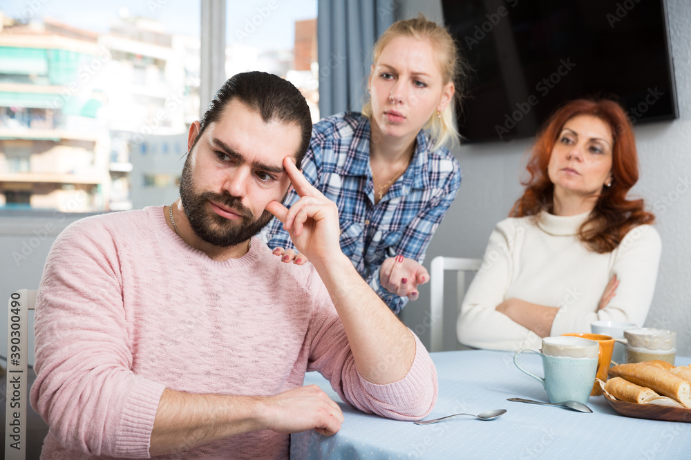 Adult guy having argue with wife and mother-in-law