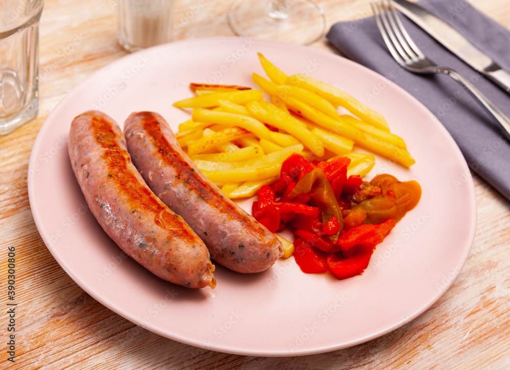 Delicious sausages and fried potatoes with stewed peppers
