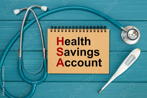Notepad with text Health Savings Account HSA and stethoscope.