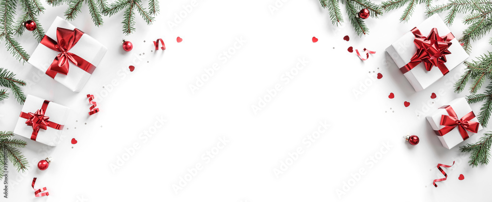 Merry Christmas card made of fir branches, gift boxes, red decoration, sparkles and confetti on white background. Xmas and New Year holiday, bokeh, light. Flat lay, top view Merry Christmas card made of fir branches, gift boxes, red decoration, sparkles and confetti on white background. Xmas and New Year holiday, bokeh, light. Flat lay, top view
