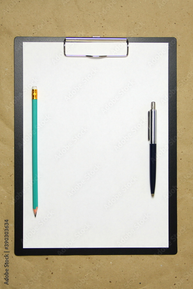 A tablet with a white sheet of A4 format on a beige craft paper.