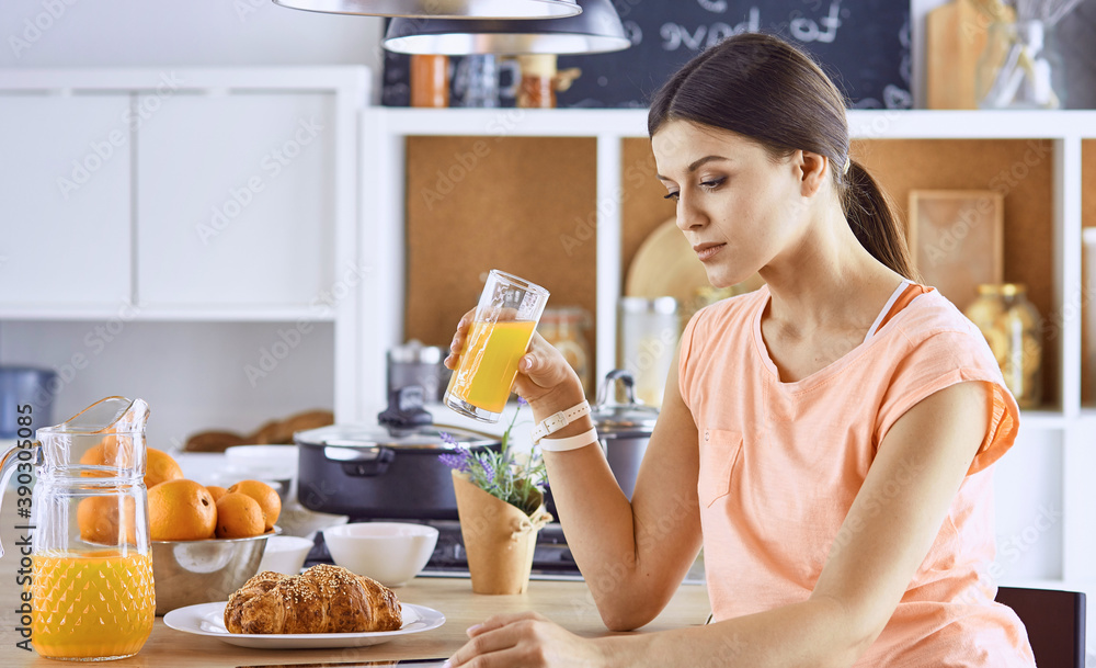 A young woman prepares food in the kitchen. Healthy food - vege A young woman prepares food in the kitchen. Healthy food - vege