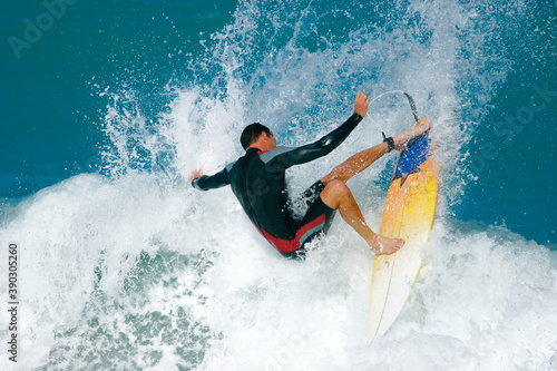Photography A surfer carves a radical off-the-lip and sends spray flying from a wave in the ocean
