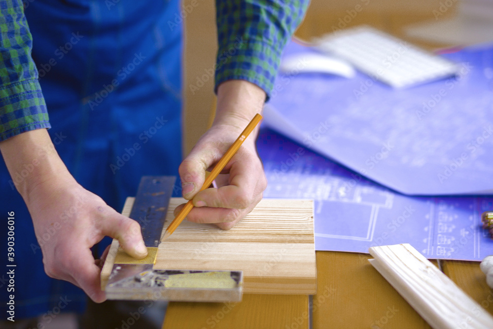 Engineer carpenter working on laptop and sketching project