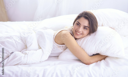 beautiful young woman basking in bed in the morning. Beautiful Model face looks sexy in camera