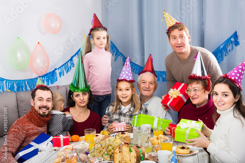 Large smiling american family having fun during children birthday party