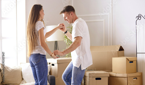 Young Hispanic couple looking at blueprints of new home, high angle view