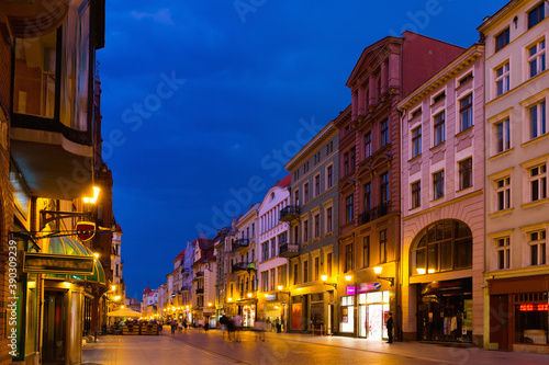 Night view of Torun streets and building illuminated at dusk, old town in Poland
