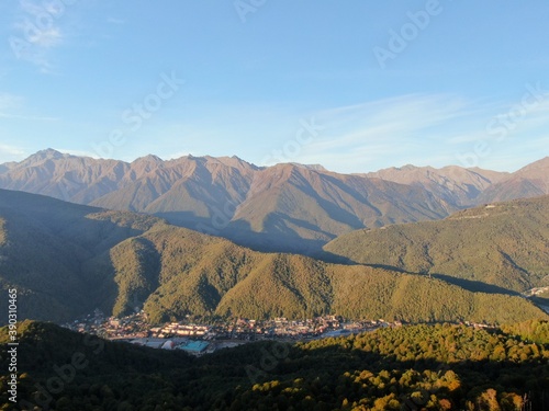 Aerial view panoramic landscape of mountains at sunset on the background of blue sky. Beautiful sunset landscape in the mountains
