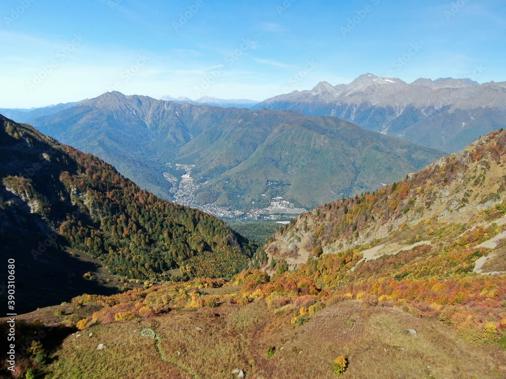 Fototapeta premium Aerial view panoramic landscape of mountains at sunset on the background of blue sky. Beautiful sunset landscape in the mountains