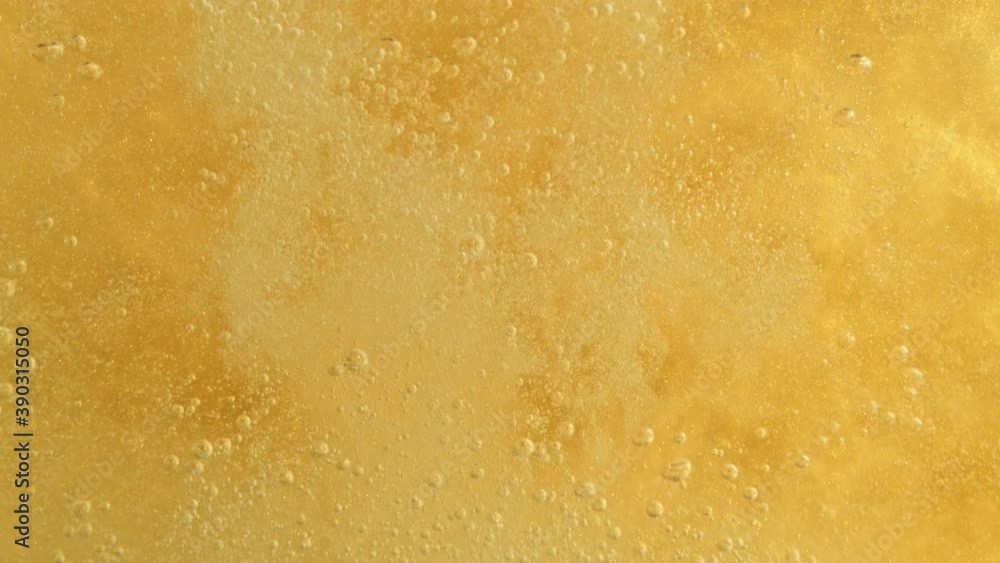 Super Slow Motion Detail Shot of Champagne Bubbles on Golden Luxury Background at 1000fps. Super Slow Motion Detail Shot of Champagne Bubbles on Golden Luxury Background at 1000fps.