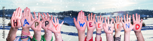 Children Hands Building Colorful Word Happy Weekend. White Winter Landscape With Snow As Background