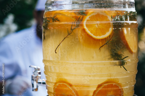 Orange fruit punch in glass jar on wedding, thirst quenching fresh made   photo