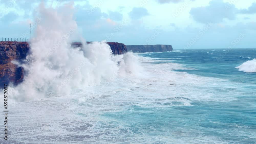 Slow motion, waves crashing against cliff with huge splashes, Sagres in Algarve of Portugal Slow motion, waves crashing against cliff with huge splashes, Sagres in Algarve of Portugal