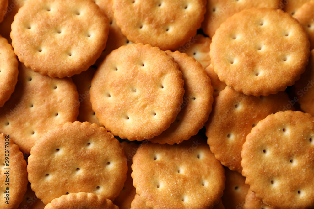 Tasty cracker biscuits on whole background, close up Tasty cracker biscuits on whole background, close up