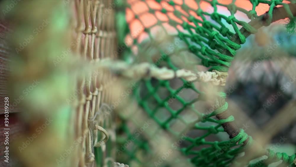 Fishing net shallow depth of field shot of crab crayfish traps. Beautiful soft slow motion shots of seafood capture device. Close up of details of netting cage Fishing net shallow depth of field shot of crab crayfish traps. Beautiful soft slow motion shots of seafood capture device. Close up of details of netting cage