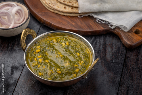 Dal palak or spinach dal is a simple recipe of lentils cooked with Indian palak or spinach and then tempered with basic spices and served with roti. photo