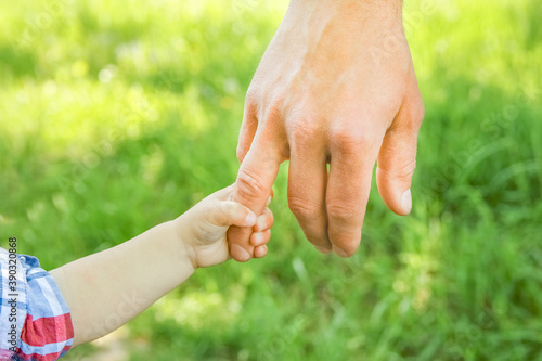 the parent holding the child's hand with a happy background © Kostia