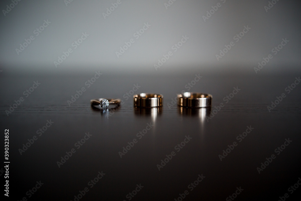 wedding gold rings on a dark wooden table wedding gold rings on a dark wooden table
