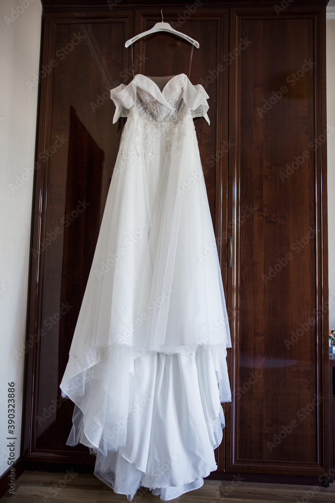 bride's wedding dress hanging on the wardrobe bride's wedding dress hanging on the wardrobe