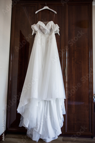 bride s wedding dress hanging on the wardrobe