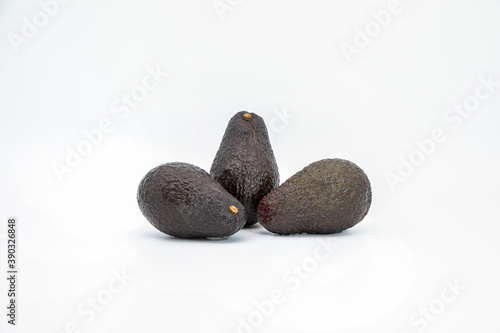 Three avocados isolated on white background.