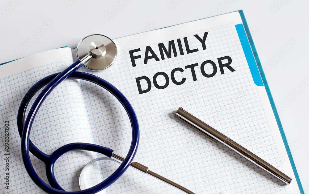 Paper with text FAMILY DOCTOR on a table with stethoscope Paper with text FAMILY DOCTOR on a table with stethoscope