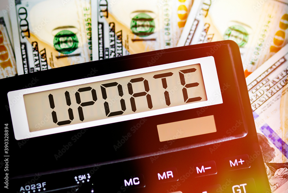 Calculator with text UPDATE on the dollars. Business, finance conceptual. Calculator with text UPDATE on the dollars. Business, finance conceptual.