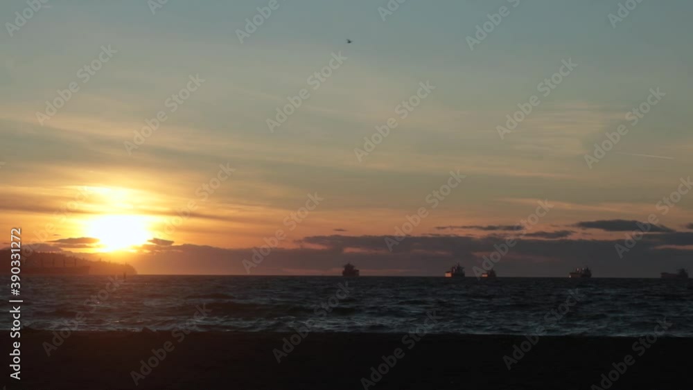 Golden sunset on a beach with freighters in the distance. Golden sunset on a beach with freighters in the distance.