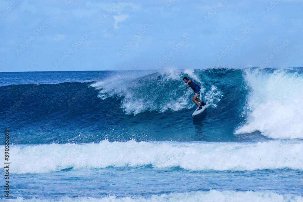 Surfer on perfect blue aquamarine wave, empty line up, perfect for surfing, clean water, Indian Ocean Surfer on perfect blue aquamarine wave, empty line up, perfect for surfing, clean water, Indian Ocean