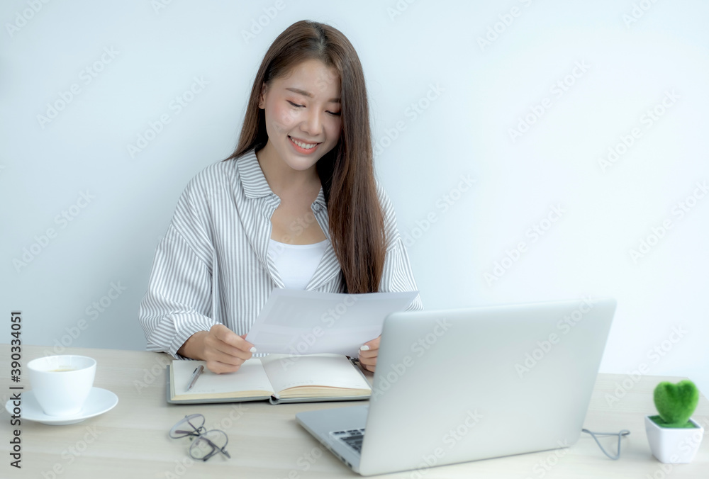 Young Asian teachers are teaching fun online from their home office, social distancing teaching concept during COVID virus diseases Young Asian teachers are teaching fun online from their home office, social distancing teaching concept during COVID virus diseases
