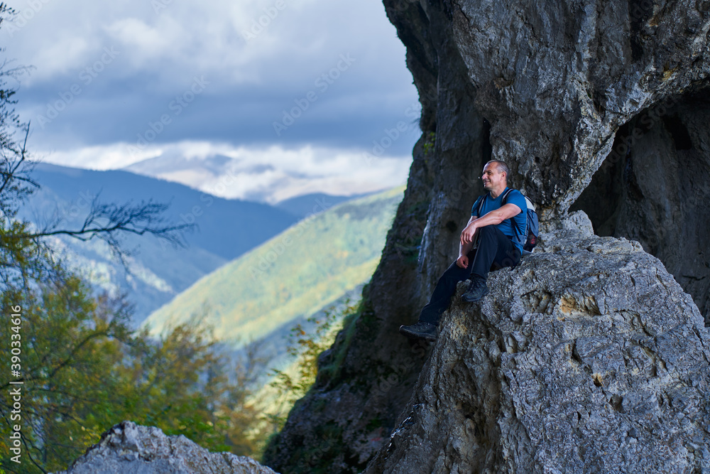 Man on a cliff in the mountains