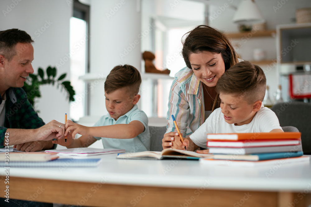 Parents helping the kids with their homework. Litlle boys learning at home. Parents helping the kids with their homework. Litlle boys learning at home.