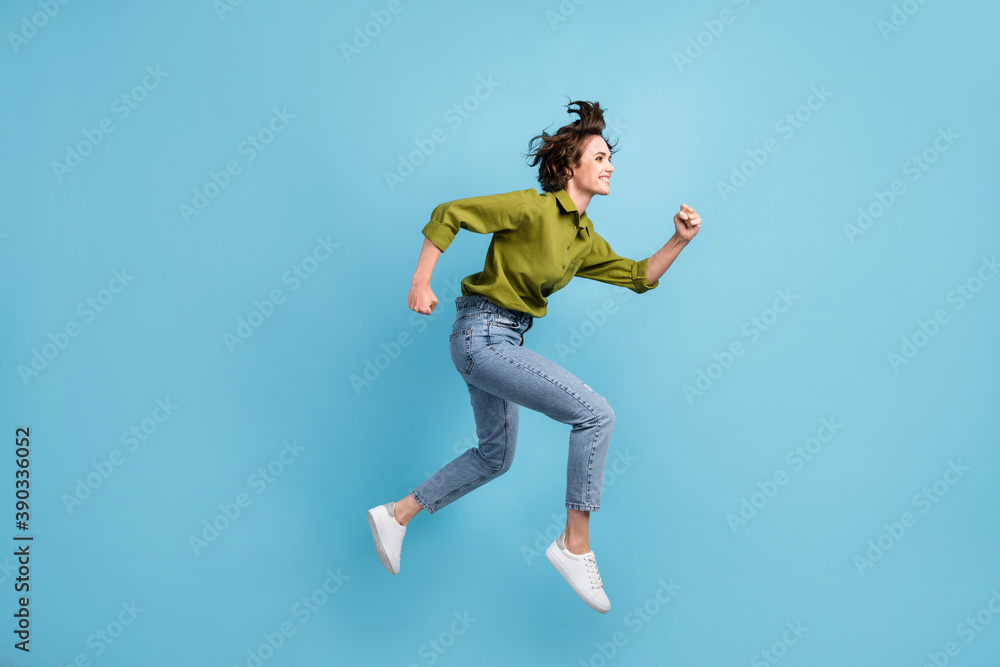 Photo portrait side view of woman running jumping up isolated on pastel light blue colored background