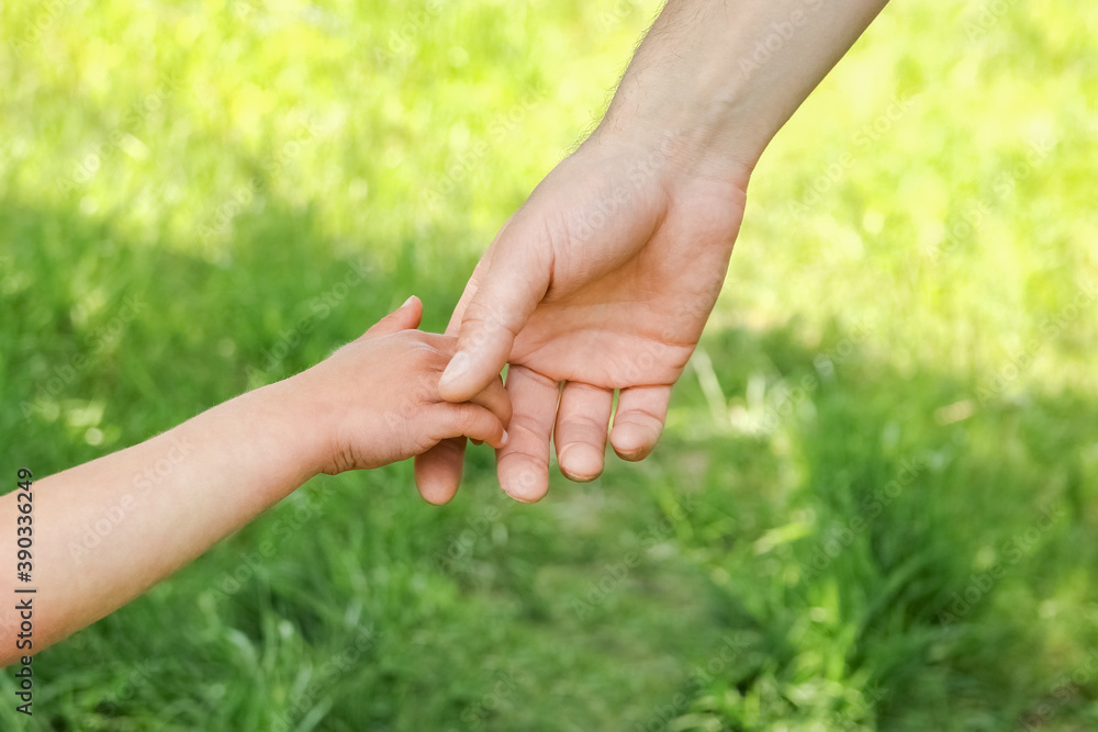 the parent holding the child's hand with a happy background the parent holding the child's hand with a happy background