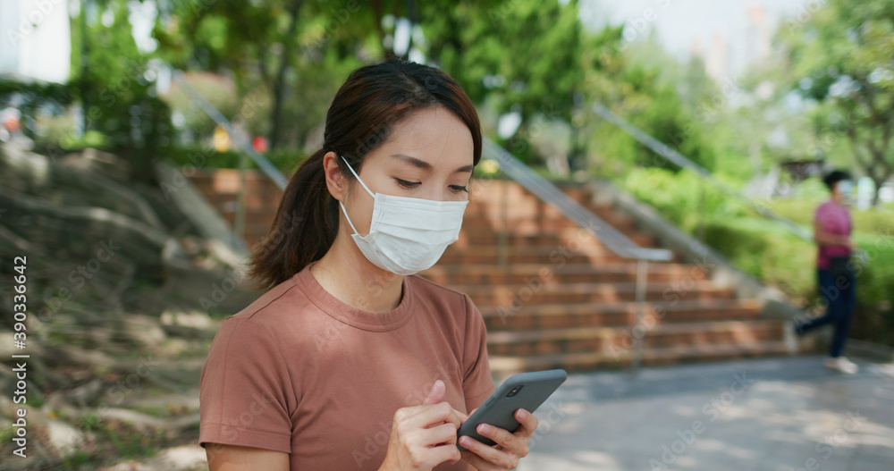 Woman wear face mask and use of smart phone at outdoor Woman wear face mask and use of smart phone at outdoor